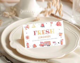 May include: A white folded place card featuring the text FRESH LEMONADE and dietary labels including gluten-free, vegetarian, vegan, and dairy-free. The card is decorated with watercolour illustrations of fire trucks, hydrants, and gear.