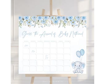Op de afbeelding: Een babyborrelbord op een ezel, met een bloemmotief van blauwe bloemen en groen. Op het bord staat "Raad de aankomst van Baby Nathaniel" en het bevat een kalender voor gasten om de uitgerekende datum te raden. Een aquarelelefant met blauwe ballonnen is ook afgebeeld.