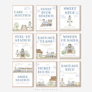 May include: Nine framed watercolor prints with a train theme. Each print has a light blue background with white text and illustrations of trains, train tracks, and clouds. The prints include phrases like "Cake Junction" and "Baggage Claim".
