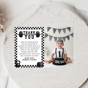 May include: A black and white first birthday thank you card with a baby photo. The card features a barbell and weight illustrations, and the text "THANK YOU". The baby is wearing a "1" shirt and a hat, with a cake that says "DUDE".