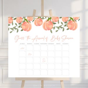 May include: A white baby shower game board on an easel, featuring a peach and green leaf design at the top. The text reads "Guess the Arrival of Baby Sharena" with a calendar grid below for guests to predict the due date.