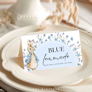 May include: A blue and white printable sign with a watercolor illustration of a bunny rabbit wearing a blue jacket. The sign says "BLUE Lemonade (DAIRY-FREE, GLUTEN-FREE, NUT-FREE)"