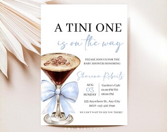 May include: Baby shower invitation with a martini glass illustration. The invitation text reads "A Tini One is on the way" in black and light blue script. Details include the honoree's name, date, time, and location.