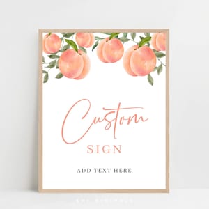 May include: A framed sign featuring a watercolour design of peaches and green leaves. The sign reads "Custom Sign" in a cursive font, with space to add text below. Ideal for a party or event.