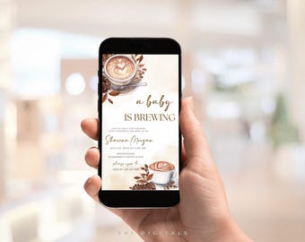 May include: A smartphone displays a baby shower invitation with a coffee theme. The invitation features watercolor illustrations of coffee cups, beans, and the phrase "a baby is brewing." The event details include the name Sharena Morgan and the date.
