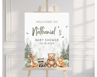 May include: A baby shower sign on an easel with the text "Welcome to Nathaniel's Baby Shower 06.18.2025." The sign features watercolor illustrations of a deer, raccoon, bear, and fox in a forest setting.