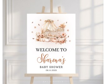 Könnte beinhalten: Ein Willkommensschild für eine Babyparty auf einer Holzstaffelei. Das Schild zeigt eine Aquarellillustration eines Kinderbetts, Kürbissen und floralen Akzenten. Der Text lautet "Welcome to Sharena's Baby Shower 08.11.2025".