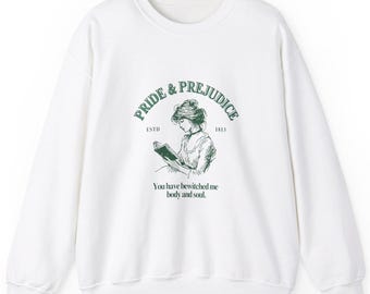 May include: White sweatshirt with a green graphic from "Pride & Prejudice." The design includes the title, a drawing of a woman reading, and the quote "You have bewitched me body and soul."