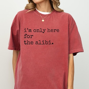 May include: An oversized red t-shirt with the text "i'm only here for the alibi." printed in black.