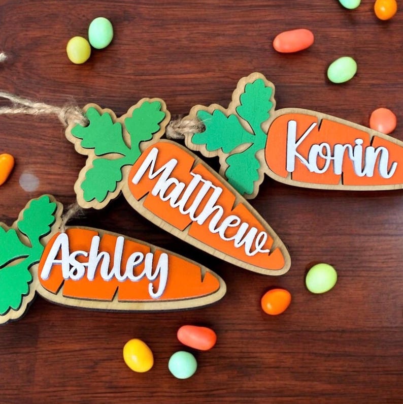 Three examples of 3D carrot Easter basket tags for kids, personalized with their first names.