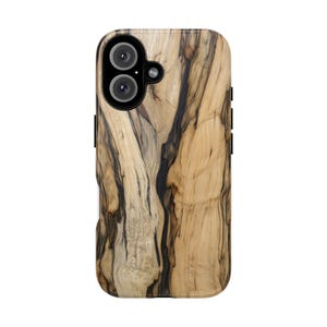 May include: A wooden phone case with a natural wood grain pattern. The case has a dual-lens camera cutout and black side buttons. The wood grain features a mix of light and dark brown tones, creating a unique, organic look.