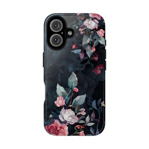 May include: A black phone case with a floral design. The flowers are pink, white, and green, and they are arranged in a vertical pattern. The case has a clear back and a black frame.