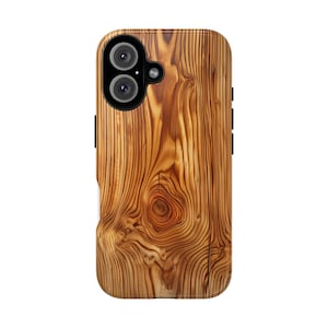 May include: A wooden-textured phone case with a natural wood grain pattern. The case has a camera cutout and side buttons. The wood grain features a knot and swirling patterns in shades of brown and tan.