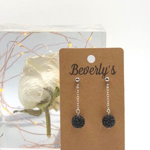 Elegant dangle-style earrings with shimmering black spheres