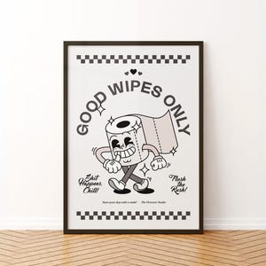 May include: A framed poster with a cartoon toilet paper roll character that says "Good Wipes Only." The character is smiling and walking. The poster also includes the phrases "Shit Happens. Chill!" and "Flush the Rush!"