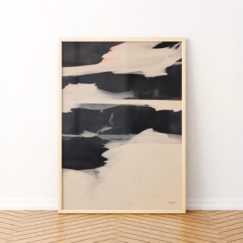 May include: Abstract art print in a light wood frame. The artwork features a composition of black, white, and pale pink brushstrokes. The lower portion is a soft beige, creating a contrast with the darker upper section. The overall style is modern and minimalist.