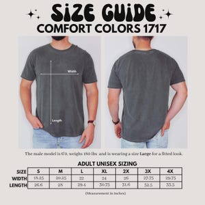 May include: Size guide for Comfort Colors 1717 t-shirts. The image shows a front and back view of a person wearing a gray t-shirt. The text includes sizing information for adult unisex sizes, with measurements in inches. The model is 6'0 and weighs 180 lbs.