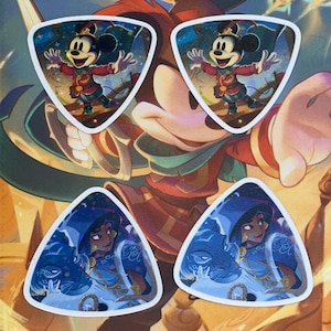 May include: Four triangular stickers featuring Disney characters. Two stickers depict Mickey Mouse in a red and gold outfit with a starry background. The other two show a woman in a blue hooded outfit with a blue background.