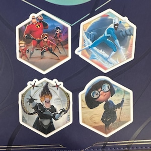 May include: Four hexagonal stickers featuring characters from The Incredibles. The stickers depict Mr. Incredible, Elastigirl, Violet, Dash, and Jack-Jack, Frozone, Syndrome, and Edna Mode. The stickers have white borders and are set against a dark blue background.
