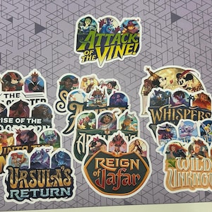 May include: A collection of colourful die-cut stickers featuring various animated characters and titles including Attack of the Vine, Rise of the Floodborn, Into the Inklands, Ursula's Return, Reign of Jafar, Whispers of the Deep, and Wilds Unknown.