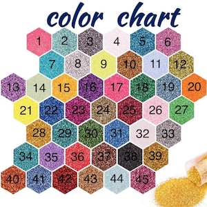 May include: A color chart featuring forty-five numbered hexagonal swatches of various glitter colors arranged in a grid. The text "color chart" appears at the top in dark blue. A small pile of loose gold glitter is visible in the bottom right corner.