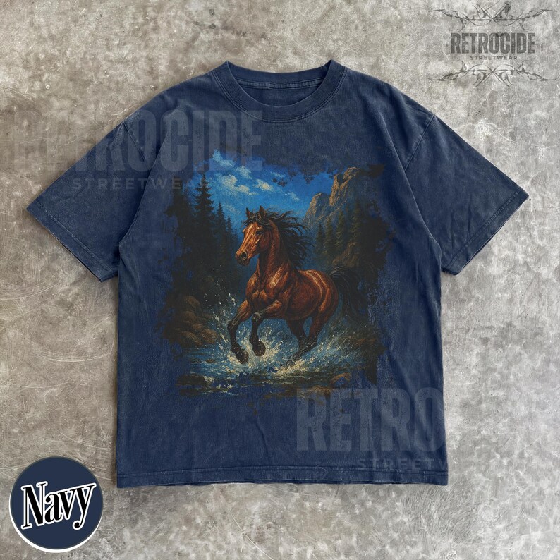 May include: Navy blue t-shirt with a brown horse graphic running through water, with mountains and trees in the background. The shirt has a faded, vintage appearance. The text "RETROCIDE STREETWEAR" is printed on the shirt.