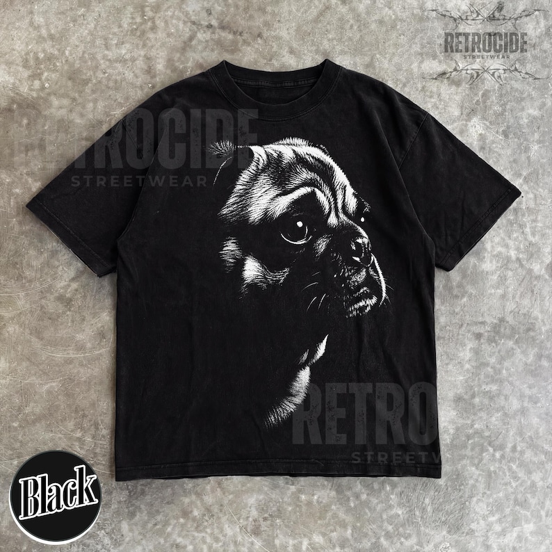 May include: A black short-sleeve t-shirt featuring a high-contrast white graphic illustration of a dog's face on the front. The design shows the detailed profile of a dog with large eyes and whiskers. The text RETROCIDE STREETWEAR is visible.