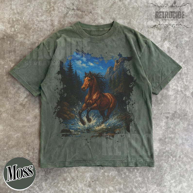 May include: Moss green t-shirt with a graphic of a brown horse running through water, set against mountains and a blue sky. The shirt has a vintage look, with the word "RETROCIDE" printed at the top. The word "Moss" is printed at the bottom.