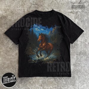 May include: Black t-shirt with a brown horse illustration, running through water, with a mountain and tree backdrop under a blue sky. The shirt has the text "RETROCIDE STREETWEAR" and a "Black" label.