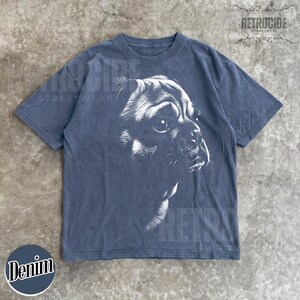 May include: A charcoal grey short-sleeve t-shirt featuring a white graphic illustration of a pug dog's face in profile. The shirt has a crew neckline and a faded, washed-out appearance. The text RETROCIDE is printed in the upper right corner.