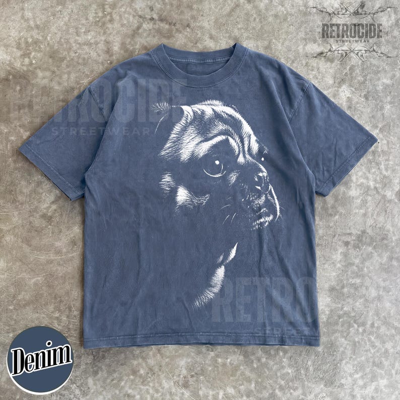 May include: A charcoal grey short-sleeve t-shirt featuring a white graphic illustration of a pug dog's face in profile. The shirt has a crew neckline and a faded, washed-out appearance. The text RETROCIDE is printed in the upper right corner.