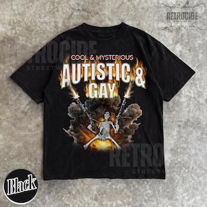 May include: Black t-shirt with the text "AUTISTIC & GAY" in a flame-like font, above a skeleton figure holding two guns. The words "COOL & MYSTERIOUS" are above the main text. The shirt has a distressed look.