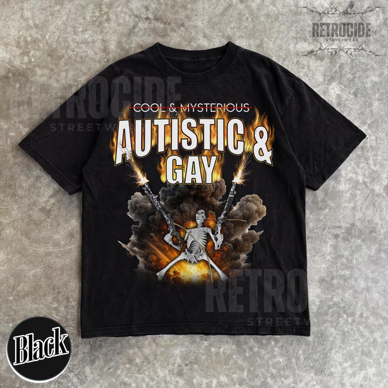 May include: Black t-shirt with the text "AUTISTIC & GAY" in a flame-like font, above a skeleton figure holding two guns. The words "COOL & MYSTERIOUS" are above the main text. The shirt has a distressed look.