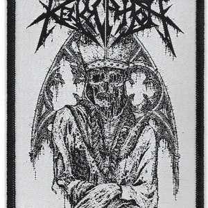 May include: Black and white embroidered patch with the text "REKVIEM" in a gothic font. The patch features a skeletal figure with wings, wearing a crown.