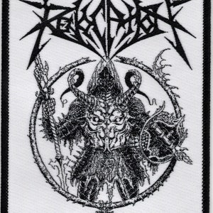 May include: Black and white embroidered patch with the band name "REVEREND" in a stylized font. The patch features a hooded figure with horns and a large, circular design behind it.