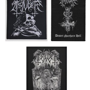 May include: Three black patches with white graphic designs. One patch features a skull, raven, and bones. Another has a cross-like design with the text "Desert Northern Hell." The third patch has a gothic illustration and the text "HelvegR."