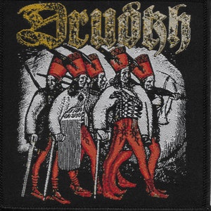 May include: Black and gold embroidered patch with the word "Scourge" in a gothic font. The patch features a black and white illustration of four figures in white robes and red pants, each holding a staff.