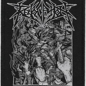 May include: Black and white embroidered patch with the word "REMARK" in a stylized font. The patch features a detailed image of a hand reaching out from a dark, shadowy background.