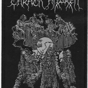 May include: Black and white embroidered patch with the text "Carach Angren" in a gothic font. The patch features a detailed image of a skull with a crown and a background of intricate patterns.