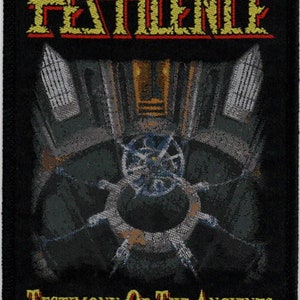 May include: A black woven patch with the band name "PESTILENCE" in yellow and red lettering. The image features a dark, intricate design with a circular element in the center. The text "TESTIMONY OF THE ANCIENTS" is displayed in yellow and red lettering at the bottom of the patch.