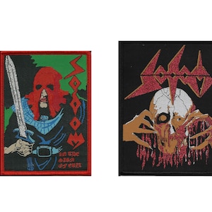 May include: Two embroidered patches, one with a red hooded figure holding a sword and the text "VOODOO In the Sign of Evil", the other with a skull with a red and black design and the text "VOODOO".