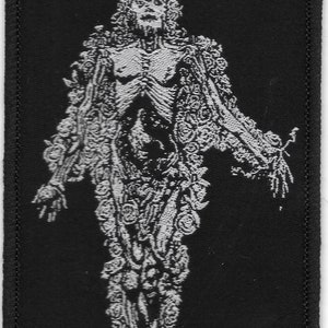 May include: Black and white embroidered patch with the text "1349" in red. The patch features a skeletal figure with a crown and ornate clothing.