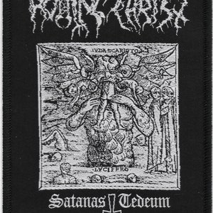 May include: Black and white embroidered patch with the text "Rotting Christ" in a gothic font. The patch features a detailed image of a winged figure with the text "Lyda Scariot" and "Lvcifero" and the words "Satanas Tedeum" below the image.