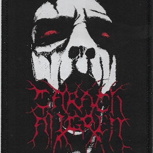 May include: Black patch featuring a white, stylized face with red eyes and a red, jagged text that reads "FORSAKEN". The patch has a black border and is likely for clothing or accessories.
