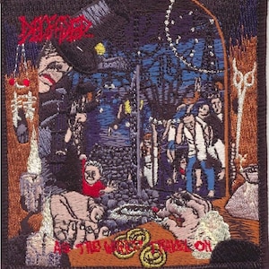 May include: A black and red embroidered patch with the text "Deicide" and "As the World Trembles On". The patch features a dark scene with a figure in a hat and a group of people in the background.