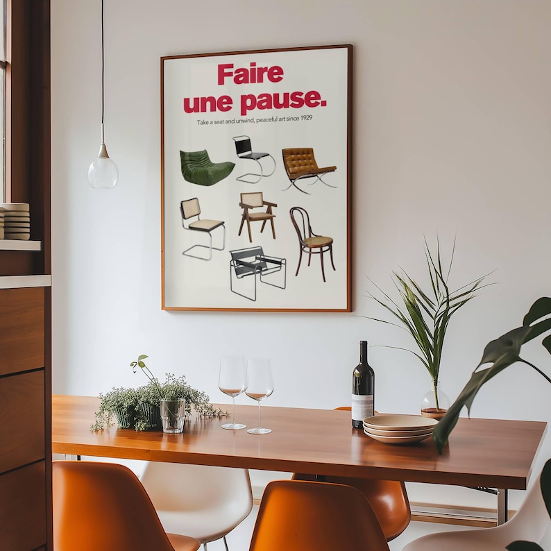 May include: A poster with the text "Faire une pause." in red and black lettering. The poster features a collection of chairs in various styles and colors. The text below the title reads "Take a seat and unwind, peaceful art since 1929."