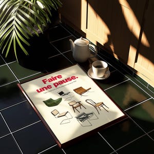 Close-up of modern art print with bold red French typography and illustrations of iconic chairs.