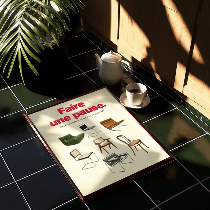 Close-up of modern art print with bold red French typography and illustrations of iconic chairs.