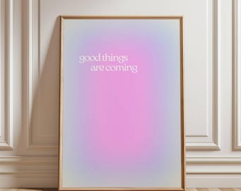 May include: A framed poster with a gradient background of purple, pink, and blue. The text "good things are coming" is printed in white on the poster.
