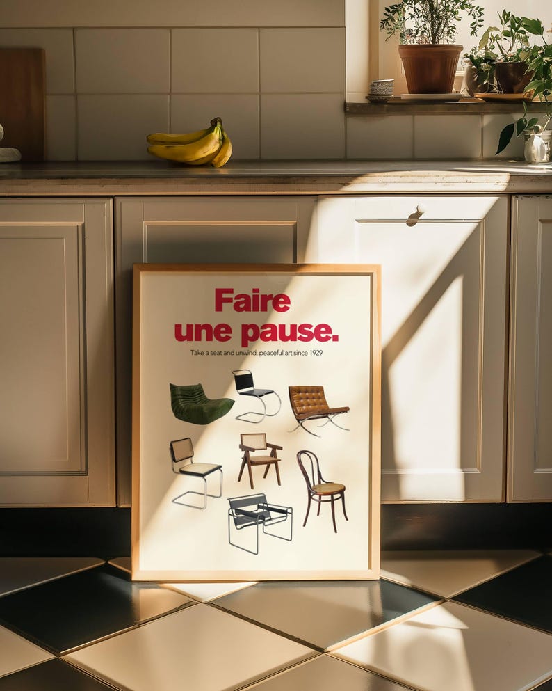 May include: A framed poster with the text "Faire une pause." in red and black lettering. The poster features a variety of chairs in different styles and colors. The text "Take a seat and unwind, peaceful art since 1929" is printed below the main text.